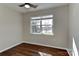 Relaxing bedroom with gleaming hardwood floors, a ceiling fan, and a window offering a peaceful view at 2013 Barkley Cir, Monroe, NC 28112