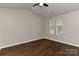 Bright bedroom featuring hardwood floors, a modern ceiling fan, and natural light from a large window at 2013 Barkley Cir, Monroe, NC 28112