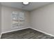 Bedroom with a window that has white blinds, light-colored walls and luxury vinyl plank flooring at 2013 Barkley Cir, Monroe, NC 28112