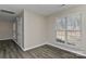 Bedroom with a window that has white blinds, light-colored walls and luxury vinyl plank flooring at 2013 Barkley Cir, Monroe, NC 28112