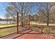 View from deck overlooking a lake and wooded area, complete with wooden railing at 2013 Barkley Cir, Monroe, NC 28112