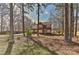 This home has a beautiful brick exterior with shuttered windows, surrounded by large trees and a natural landscape at 2013 Barkley Cir, Monroe, NC 28112