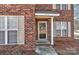 Close-up of the front entrance featuring brick facade and covered porch at 2013 Barkley Cir, Monroe, NC 28112