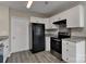 Modern kitchen with sleek appliances, white cabinets, and gray counter tops at 2013 Barkley Cir, Monroe, NC 28112