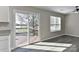 View of a living room with sliding glass doors to an outdoor deck overlooking a lake at 2013 Barkley Cir, Monroe, NC 28112