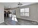 Living room with a view of a modern kitchen, glass doors to deck and natural light from window at 2013 Barkley Cir, Monroe, NC 28112