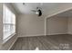 Bright living room featuring a ceiling fan, neutral paint, and large windows allowing ample natural light at 2013 Barkley Cir, Monroe, NC 28112