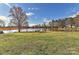 Picturesque view of a pond with a dock and seating area, perfect for lakeside enjoyment at 2013 Barkley Cir, Monroe, NC 28112