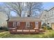 A spacious wooden deck sits attached to the rear of this brick home, perfect for outdoor gatherings at 2309 Shenandoah Ave, Charlotte, NC 28205