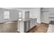 Kitchen island with a stainless steel sink, gray cabinets, and granite countertops at 3016 Sassafras Trl, Gastonia, NC 28056