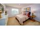 Cozy bedroom with neutral tones, soft carpet, and a large window for natural light at 3021 Sassafras Trl, Gastonia, NC 28056