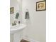 Close-up of bathroom sink with brushed nickel faucet and wall decor at 3097 Arches Bluff Cir, Lancaster, SC 29720