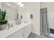 Modern bathroom features a white countertop, vanity, large mirror, and shower with curtain at 3097 Arches Bluff Cir, Lancaster, SC 29720