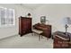 Bright room showcases piano, dark wooden cabinet, lamp, floral bench, and carpeted floors at 3097 Arches Bluff Cir, Lancaster, SC 29720