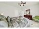 Comfortable bedroom featuring neutral walls, ceiling fan, and well-lit bathroom and dresser at 3097 Arches Bluff Cir, Lancaster, SC 29720