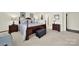 A spacious bedroom features a luxurious bed, carpeting and an ensuite bathroom at 3097 Arches Bluff Cir, Lancaster, SC 29720