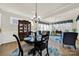 Bright dining room features a round table, hutch and large windows with blue valances at 3097 Arches Bluff Cir, Lancaster, SC 29720