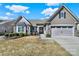 Charming home featuring stone accents, a manicured front yard, and an attached two car garage at 3097 Arches Bluff Cir, Lancaster, SC 29720