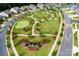 Overhead view of community green space with putting green and sidewalks at 3097 Arches Bluff Cir, Lancaster, SC 29720