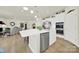 Bright kitchen featuring an island, stainless steel appliances, and hardwood floors at 3097 Arches Bluff Cir, Lancaster, SC 29720