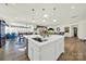 Bright kitchen featuring an island, stainless steel appliances, and hardwood floors at 3097 Arches Bluff Cir, Lancaster, SC 29720