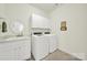 Laundry room featuring washer, dryer, white cabinets, and a sink with decor at 3097 Arches Bluff Cir, Lancaster, SC 29720