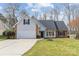 Charming home featuring a two-car garage, brick accents, and a well-manicured lawn at 3919 Chatterleigh Dr, Monroe, NC 28110