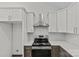 Kitchen with stainless steel appliances, white cabinets, quartz counters and decorative backsplash at 3919 Chatterleigh Dr, Monroe, NC 28110