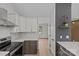 Kitchen with stainless steel appliances, white cabinets and decorative details at 3919 Chatterleigh Dr, Monroe, NC 28110