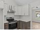 Kitchen with stainless steel appliances, white cabinets, quartz counters and decorative backsplash at 3919 Chatterleigh Dr, Monroe, NC 28110