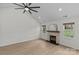 Bright living room featuring a fireplace, neutral walls, ceiling fan, and wood-look flooring at 3919 Chatterleigh Dr, Monroe, NC 28110