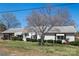 Charming single-story home featuring a well-maintained lawn and classic white siding and awning-covered windows at 403 E 27Th St, Kannapolis, NC 28083