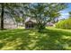Spacious backyard with lush green grass, mature trees, and an enclosed porch at 404 E 1St St, Cherryville, NC 28021