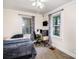 Bedroom with neutral colored walls, light carpet, ceiling fan, two windows, and workstation at 404 E 1St St, Cherryville, NC 28021