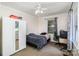 Well lit bedroom with neutral colored walls, light carpet, ceiling fan, window, and workstation at 404 E 1St St, Cherryville, NC 28021
