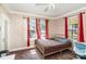 Cozy bedroom featuring beautiful windows, ceiling fan, neutral walls, and hardwood floors at 404 E 1St St, Cherryville, NC 28021