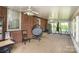 Enclosed porch with brick and light colored walls, carpet floors, windows, and ceiling fans at 404 E 1St St, Cherryville, NC 28021