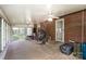 Enclosed porch with brick and light colored walls, carpet floors, windows, and ceiling fans at 404 E 1St St, Cherryville, NC 28021