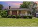 Charming brick home featuring a cozy front porch and well-manicured landscaping in a beautiful neighborhood at 404 E 1St St, Cherryville, NC 28021