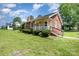 A charming, brick-clad house with a cozy front porch and well-maintained lawn, perfect for enjoying outdoor living at 404 E 1St St, Cherryville, NC 28021