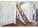 Inviting hallway with classic staircase and ample closet space, leading to the upper levels of the home at 404 E 1St St, Cherryville, NC 28021