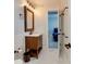 Cozy bathroom featuring a wood vanity with mirror and fixtures, adjacent to a bedroom at 4216 Maureen Dr, Charlotte, NC 28205