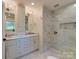 Elegant bathroom with marble walk-in shower, dual vanity, and stylish fixtures at 4216 Maureen Dr, Charlotte, NC 28205