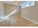 Bright bedroom with a ceiling fan and window that lets in natural light, featuring neutral tones for a serene atmosphere at 4216 Maureen Dr, Charlotte, NC 28205