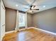 Empty bedroom featuring hardwood floors, neutral paint, a ceiling fan, and a window with sheer curtains at 4216 Maureen Dr, Charlotte, NC 28205