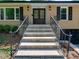 Inviting home entrance featuring a tiled staircase, metal handrails, and a stylish double-door entryway at 4216 Maureen Dr, Charlotte, NC 28205