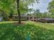 Charming home with a manicured lawn and mature trees at 4216 Maureen Dr, Charlotte, NC 28205