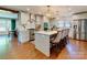 Bright kitchen features hardwood floors, a large island with seating, and stainless steel appliances at 4216 Maureen Dr, Charlotte, NC 28205