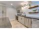 Well-equipped kitchen with stainless steel appliances, subway tile backsplash, granite countertops, and open shelving for storage at 4216 Maureen Dr, Charlotte, NC 28205