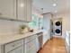 Modern kitchen featuring white cabinetry, subway tile backsplash, stainless steel appliances, and hardwood floors at 4216 Maureen Dr, Charlotte, NC 28205